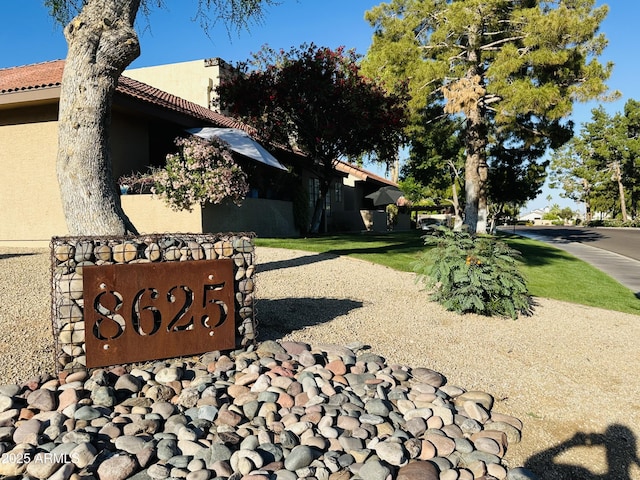 exterior space with stucco siding and a tile roof