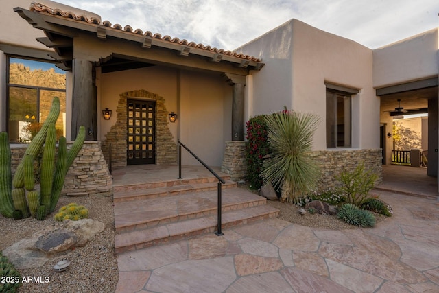 property entrance featuring stone siding and stucco siding