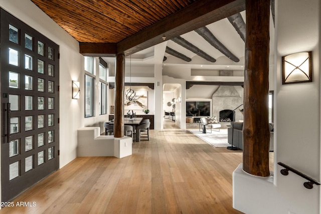 foyer entrance featuring hardwood / wood-style flooring, wooden ceiling, and beamed ceiling