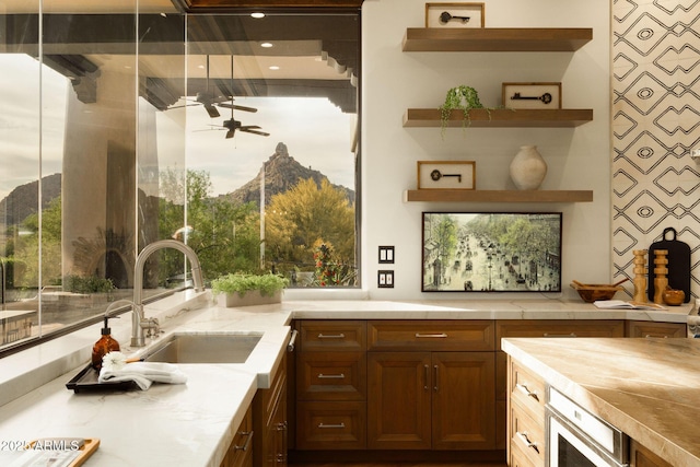 interior space featuring ceiling fan and a sink