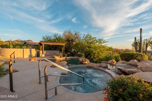 pool featuring fence, a patio area, and an in ground hot tub