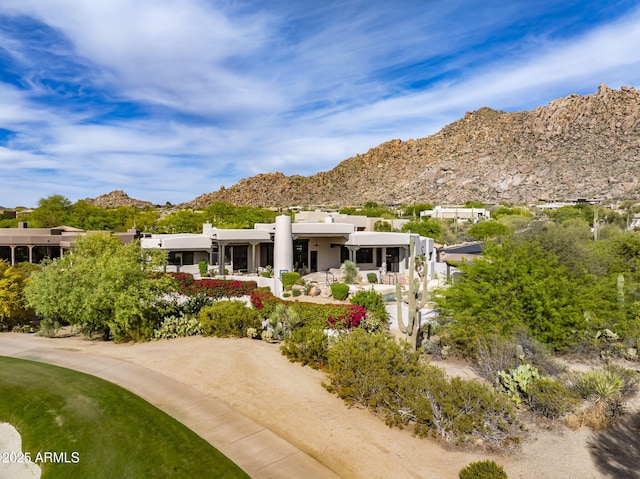 exterior space featuring stucco siding and a mountain view
