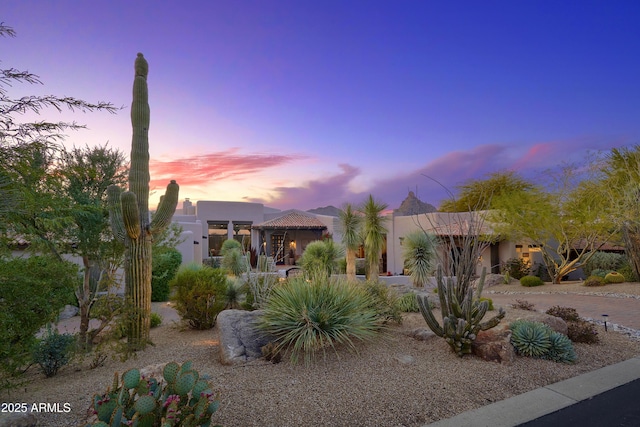 southwest-style home with stucco siding and a chimney