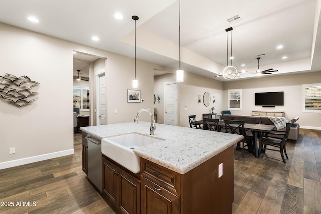 kitchen featuring a sink, visible vents, a ceiling fan, stainless steel dishwasher, and a raised ceiling