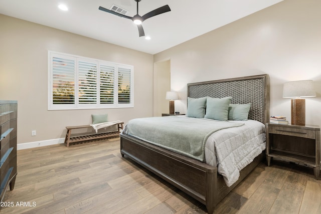 bedroom with recessed lighting, visible vents, a ceiling fan, wood finished floors, and baseboards