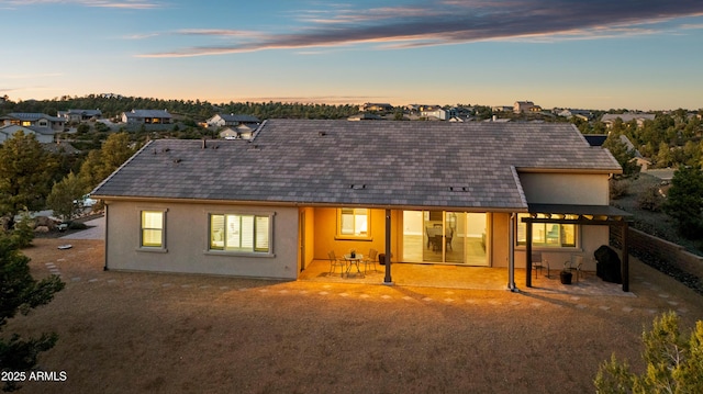 back of property with fence, a patio, and stucco siding