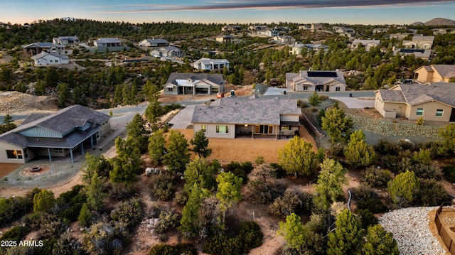 aerial view at dusk featuring a residential view