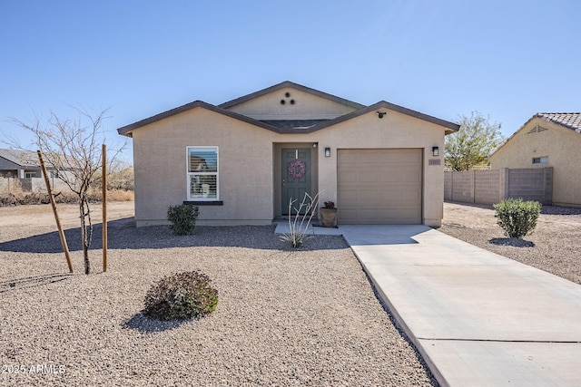 ranch-style house with an attached garage, concrete driveway, and stucco siding