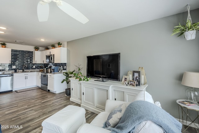 living room featuring visible vents, dark wood finished floors, a ceiling fan, and recessed lighting