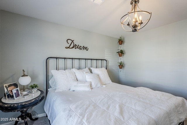 carpeted bedroom featuring a notable chandelier