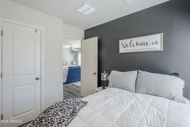 bedroom with visible vents and wood finished floors