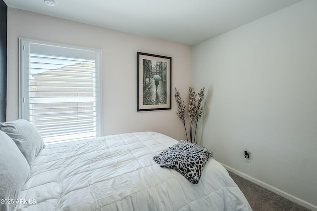 bedroom featuring carpet floors and baseboards