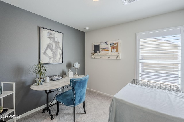 office featuring baseboards, visible vents, and light colored carpet