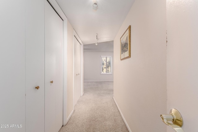 hall with light colored carpet