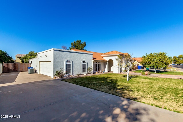 view of front of property featuring a garage, a front lawn, and central air condition unit