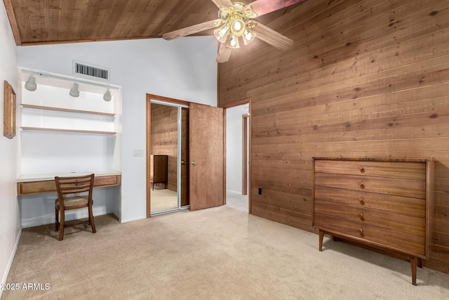 carpeted bedroom with ceiling fan, high vaulted ceiling, wood walls, and wood ceiling