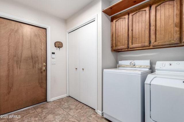 washroom with cabinets, independent washer and dryer, and light tile patterned flooring