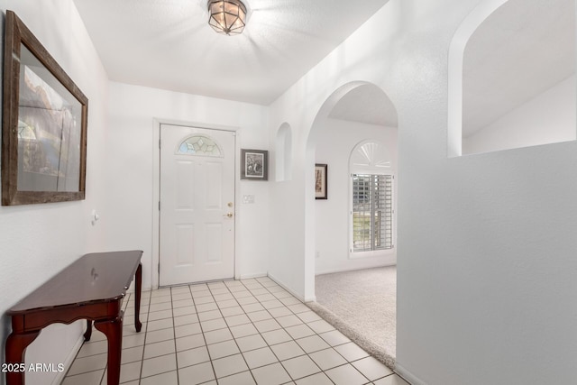 foyer entrance with light carpet