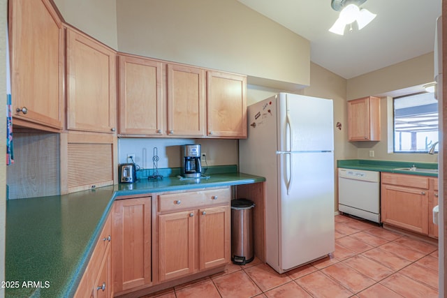 kitchen with light tile patterned floors, light brown cabinetry, lofted ceiling, and white appliances