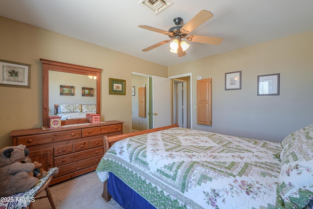 bedroom featuring a ceiling fan, visible vents, and carpet
