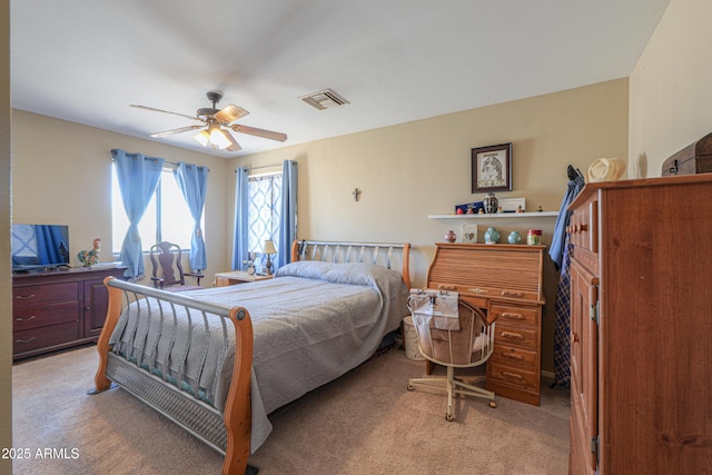 bedroom featuring visible vents, ceiling fan, and light carpet
