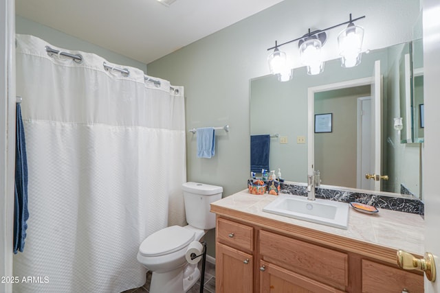 bathroom featuring toilet, tile patterned floors, and vanity