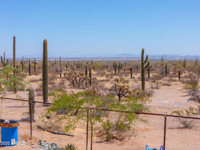 view of yard featuring fence and a rural view