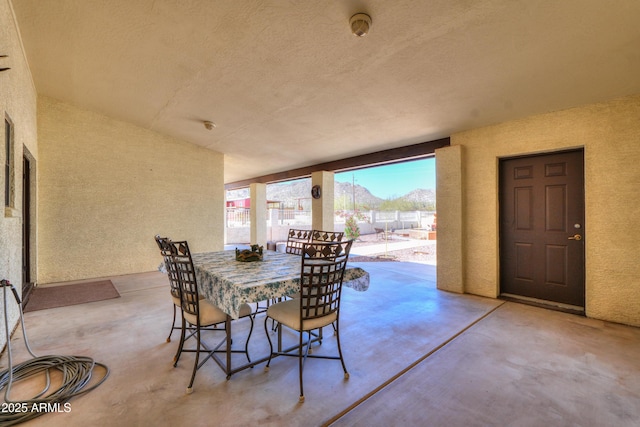 view of patio / terrace with a mountain view and fence