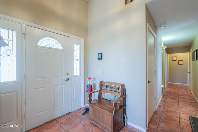 entryway with light tile patterned floors, visible vents, and baseboards