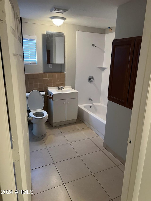 full bathroom featuring vanity, tile patterned floors, toilet, shower / bathing tub combination, and tile walls