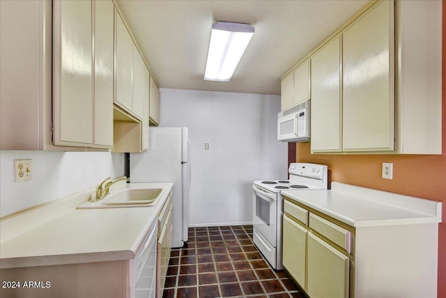 kitchen featuring cream cabinets, white appliances, and sink