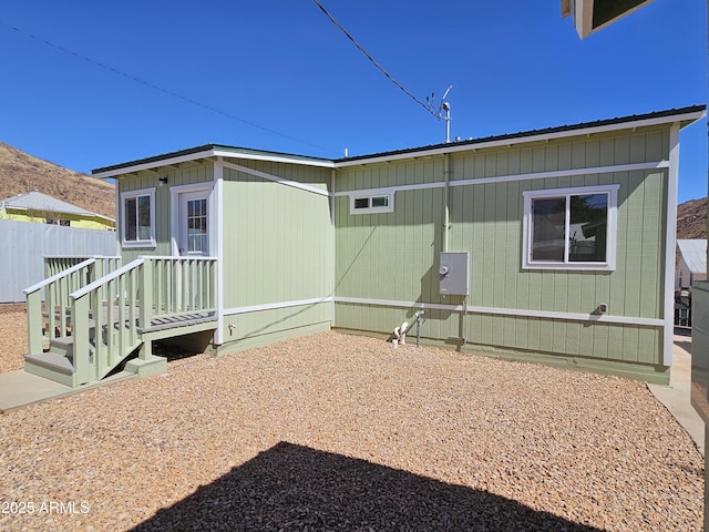 back of house featuring fence