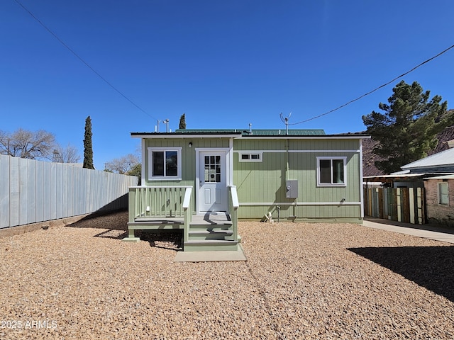 back of property featuring fence