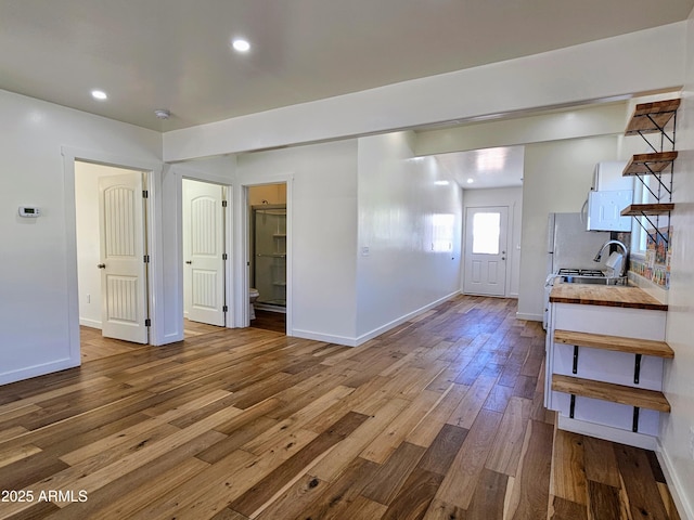 entrance foyer featuring recessed lighting, hardwood / wood-style flooring, and baseboards