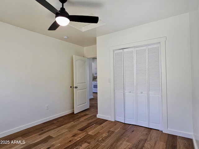 unfurnished bedroom with ceiling fan, a closet, baseboards, and wood finished floors