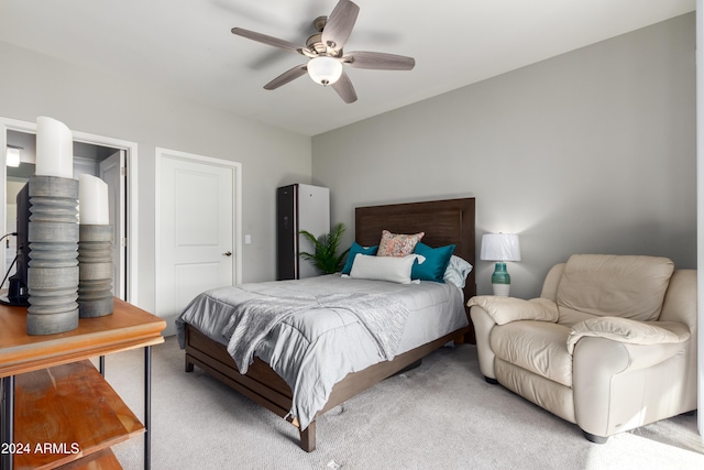 bedroom featuring light colored carpet and ceiling fan