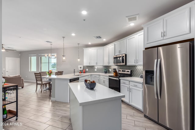 kitchen featuring stainless steel appliances, tasteful backsplash, light countertops, visible vents, and a peninsula