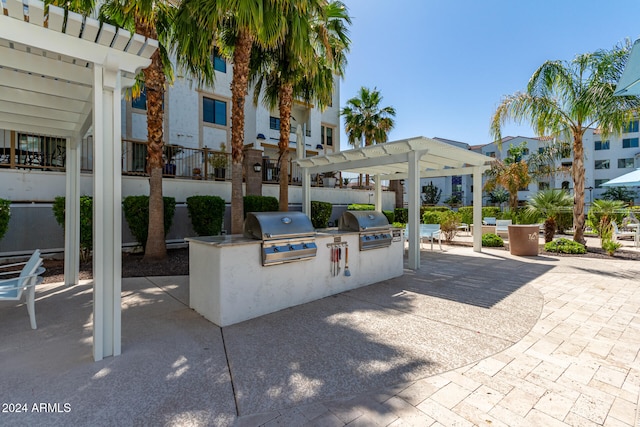 view of patio / terrace featuring an outdoor kitchen, area for grilling, and a pergola