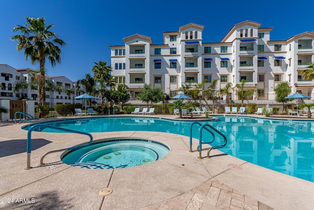 view of swimming pool with a community hot tub