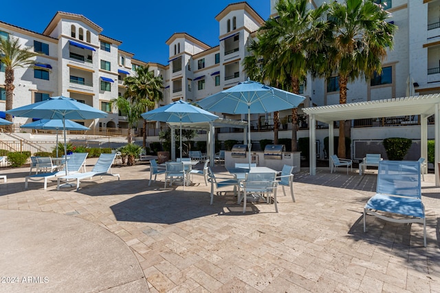 view of patio / terrace with a balcony, area for grilling, and a pergola