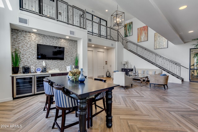 dining room with beverage cooler, visible vents, stairway, and baseboards