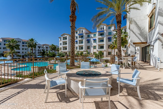 view of patio / terrace with an outdoor fire pit and a community pool