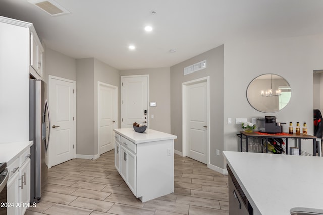 kitchen featuring a center island, stainless steel fridge with ice dispenser, an inviting chandelier, white cabinets, and light hardwood / wood-style flooring