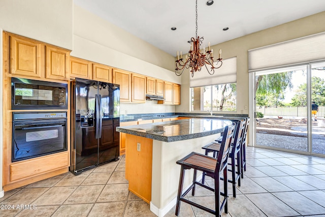 kitchen with light tile patterned floors, backsplash, an inviting chandelier, and black appliances