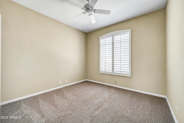 empty room featuring carpet flooring and ceiling fan