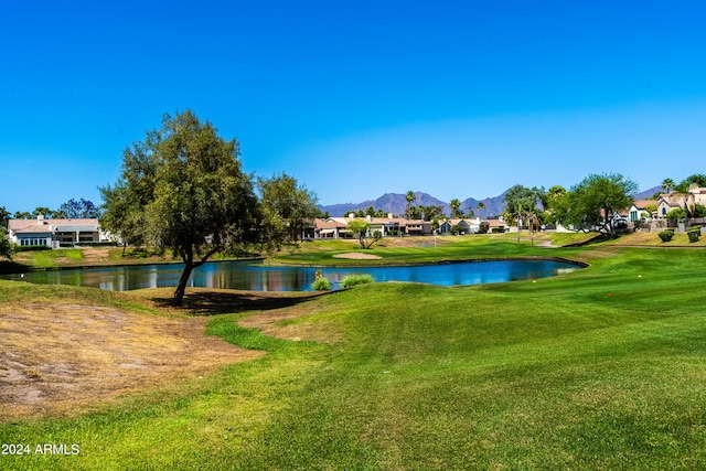 view of community with a yard and a water and mountain view