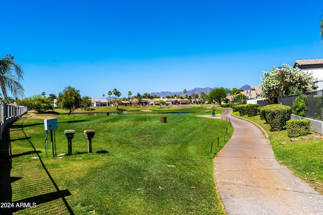 view of property's community featuring a mountain view and a yard