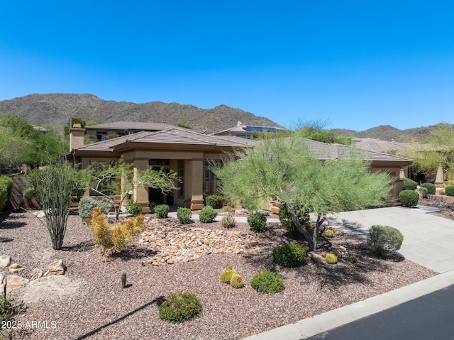 view of front of property with a mountain view, stucco siding, and a tile roof