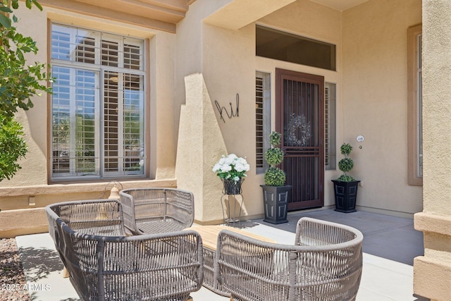 doorway to property with stucco siding and a patio