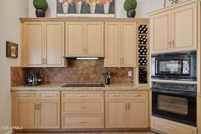 kitchen with black appliances, light brown cabinets, and decorative backsplash